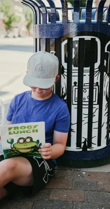 Kid reading frogs lunch Kid reading frogs lunch